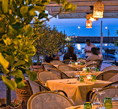 Restaurant with tables by the sea Capri